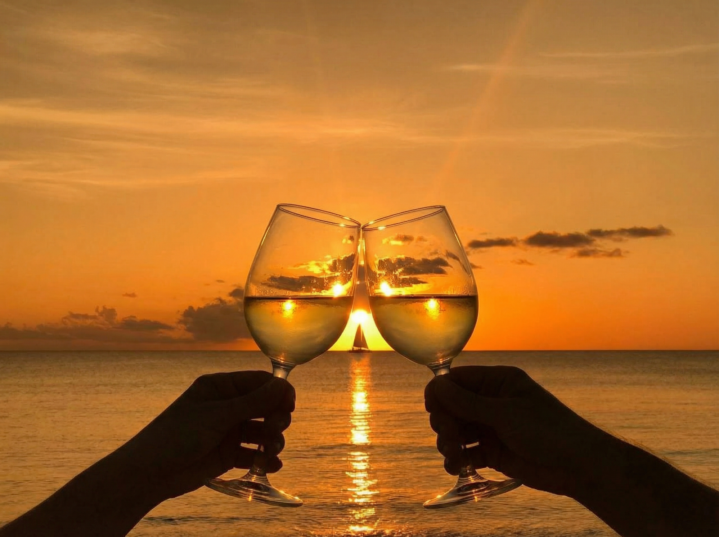 Cayman sunset cheers with white wine glasses